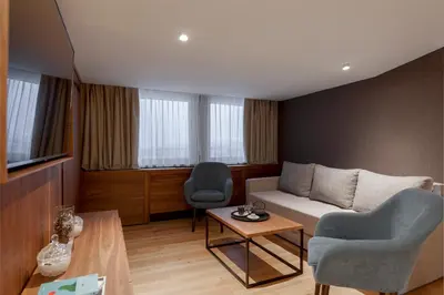 a living room with a couch and two chairs and a table at Hotel Grand Kopaonik in Kopaonik