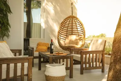 a porch with chairs and a table and a swing at Apartmani Freedom place in Jagodina