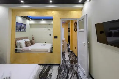 a bedroom with a bed and a tv in a room at Andjela Lux in Vrnjačka Banja