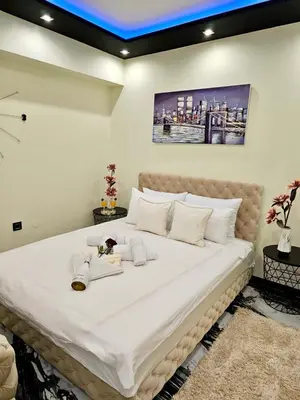 a bedroom with a large bed with white sheets at Andjela Lux in Vrnjačka Banja