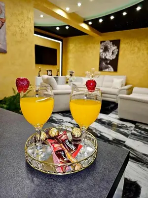 two glasses of orange juice on a tray on a table at Andjela Lux in Vrnjačka Banja