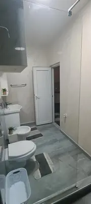 a bathroom with two toilets and a glass door at Andjela Lux in Vrnjačka Banja