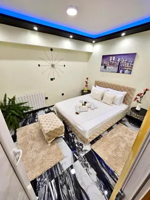 a bedroom with a large bed and a clock on the wall at Andjela Lux in Vrnjačka Banja