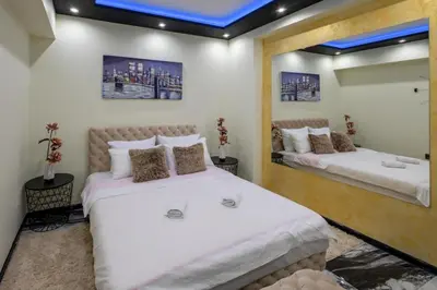 a bedroom with two beds and a mirror at Andjela Lux in Vrnjačka Banja