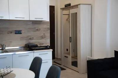 a kitchen with a sink and a table with chairs at Milmari Nlux 74 in Kopaonik
