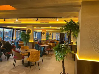 a restaurant with tables and chairs and people sitting at tables at Milmari Nlux 74 in Kopaonik