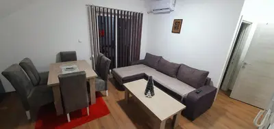 a living room with a couch and a table at Zlatna iskra in Ruđinci