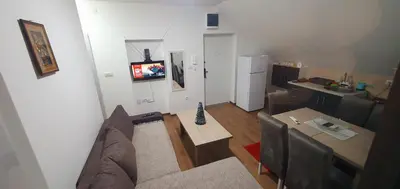 a living room with a couch and a table at Zlatna iskra in Ruđinci