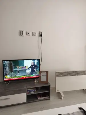 a flat screen tv sitting on top of a entertainment center at Maki i Jeka in Soko Banja