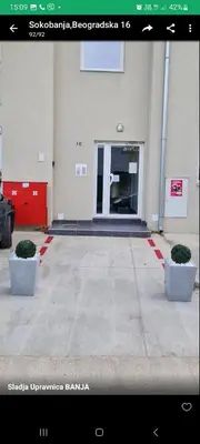 a building with two bushes in front of a door at Maki i Jeka in Soko Banja
