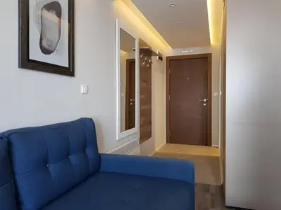 a blue couch in a room with a hallway at RELAX MILMARI-kopaonik in Kopaonik