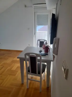 a table with a chair and a computer on it at Apartman Ilic in Vrnjačka Banja