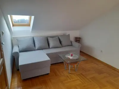 a living room with a couch and a table at Apartman Ilic in Vrnjačka Banja