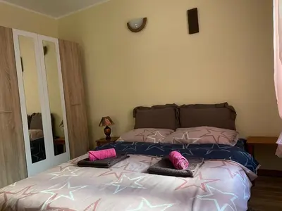 a bedroom with a bed with two pillows on it at Vitez Koja in Vrnjačka Banja