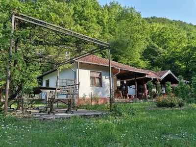 a small house with a chair in front of it at Vitez Koja in Vrnjačka Banja