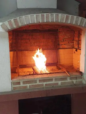 a brick oven with a fire inside of it at Vitez Koja in Vrnjačka Banja