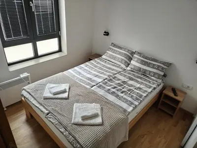 a bedroom with a bed with two towels on it at Apartman Ida in Soko Banja