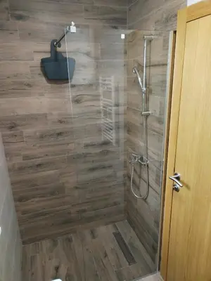 a bathroom with a shower with a glass door at Apartman Ida in Soko Banja