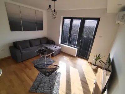 a living room with a couch and a table at Apartman Ida in Soko Banja