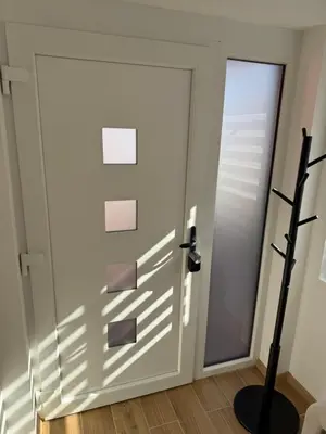 a door with a shadow on the wall at Hestia Suite in Zaječar