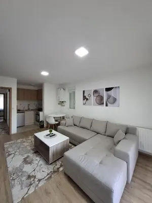 a living room with a couch and a table at Apartmani Bojković in Vrnjačka Banja