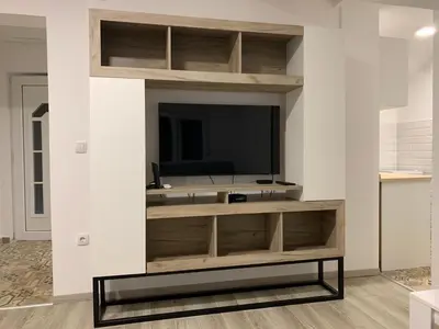 a living room with a tv on a wall at Apartman MIMI in Vrnjačka Banja