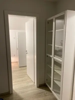 an empty room with a white door and a closet at Apartman MIMI in Vrnjačka Banja