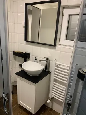 a bathroom with a white sink and a mirror at Apartman MIMI in Vrnjačka Banja