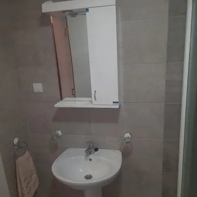 a bathroom with a white sink and a mirror at Apartman Ignjatović in Vrnjačka Banja