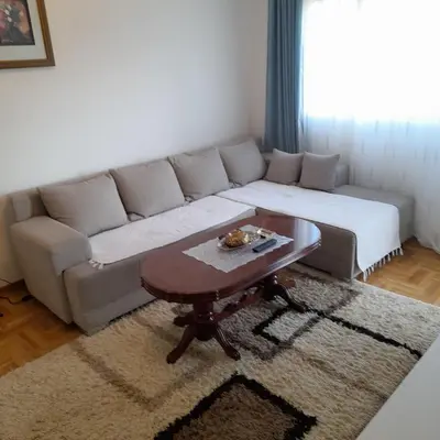 a living room with a couch and a coffee table at Apartman Ignjatović in Vrnjačka Banja
