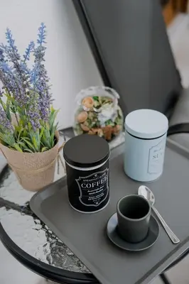 a tray with a cup of coffee on a table with flowers at Vrnjačka Promenada - Pešačka zona - Baby friendly in Vrnjačka Banja