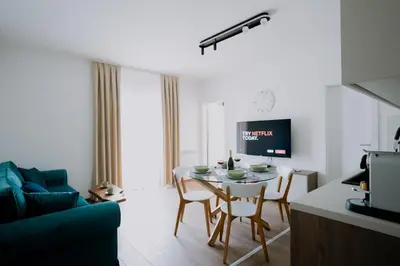 a kitchen and living room with a table and chairs at Terra Apartments in Vrnjačka Banja