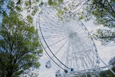 a large ferris wheel in a park with trees at Terra Apartments in Vrnjačka Banja