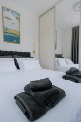 a group of towels sitting on top of a bed at Terra Apartments in Vrnjačka Banja