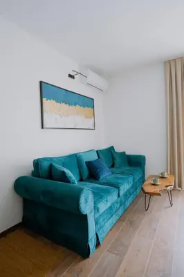 a blue couch sitting in a living room at Terra Apartments in Vrnjačka Banja