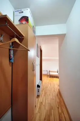 a room with a hallway with a couch and a room with at Apartman Dačić in Vrnjačka Banja
