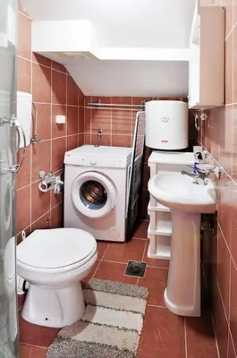 a bathroom with a toilet sink and a washing machine at Apartman Dačić in Vrnjačka Banja