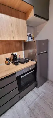 a kitchen with a counter and a refrigerator at Apartman Rojal Vranje in Vranje