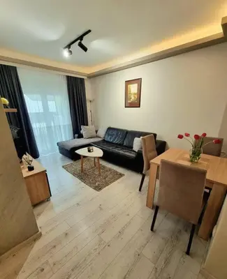 a living room with a couch and a table at Apartman Rojal Vranje in Vranje
