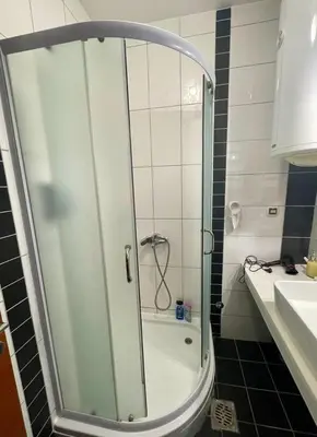 a shower with a glass door in a bathroom at Apartman Marija in Vrnjačka Banja