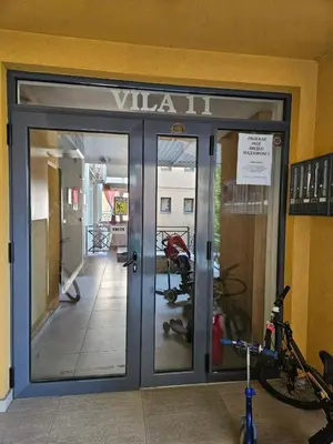 a glass door to a gym with a bike outside at Apartman Marija in Vrnjačka Banja
