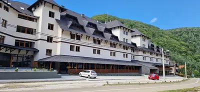 a large building with a car parked in front of it at ANIMA Bela reka C121, Brzeće in Brzeće