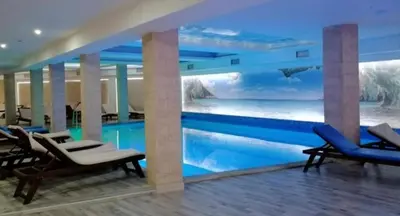 a swimming pool in a hotel with a mural at Apartman na Kopaoniku in Kopaonik