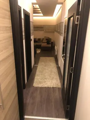 a hallway leading to a living room with a couch at Apartman na Kopaoniku in Kopaonik