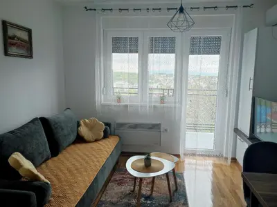 a living room with a couch and a table at Apartman Desanka in Vrnjačka Banja