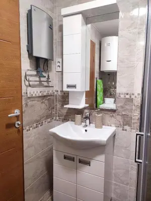 a bathroom with a white sink and a mirror at Apartman Desanka in Vrnjačka Banja