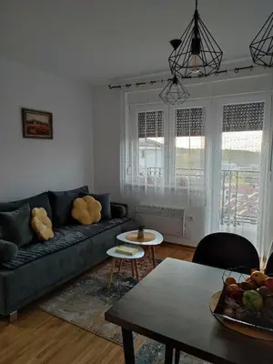 a living room with a couch and a table at Apartman Desanka in Vrnjačka Banja