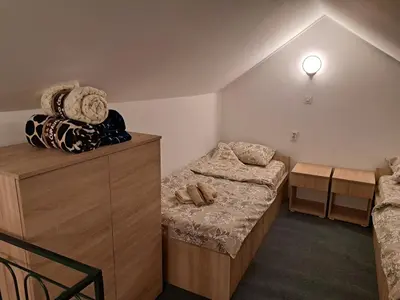 a small room with two beds and a table at Daka in Vrnjačka Banja