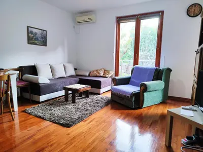 a living room with a couch and chairs and a table at Apartman 5ra in Vrnjačka Banja